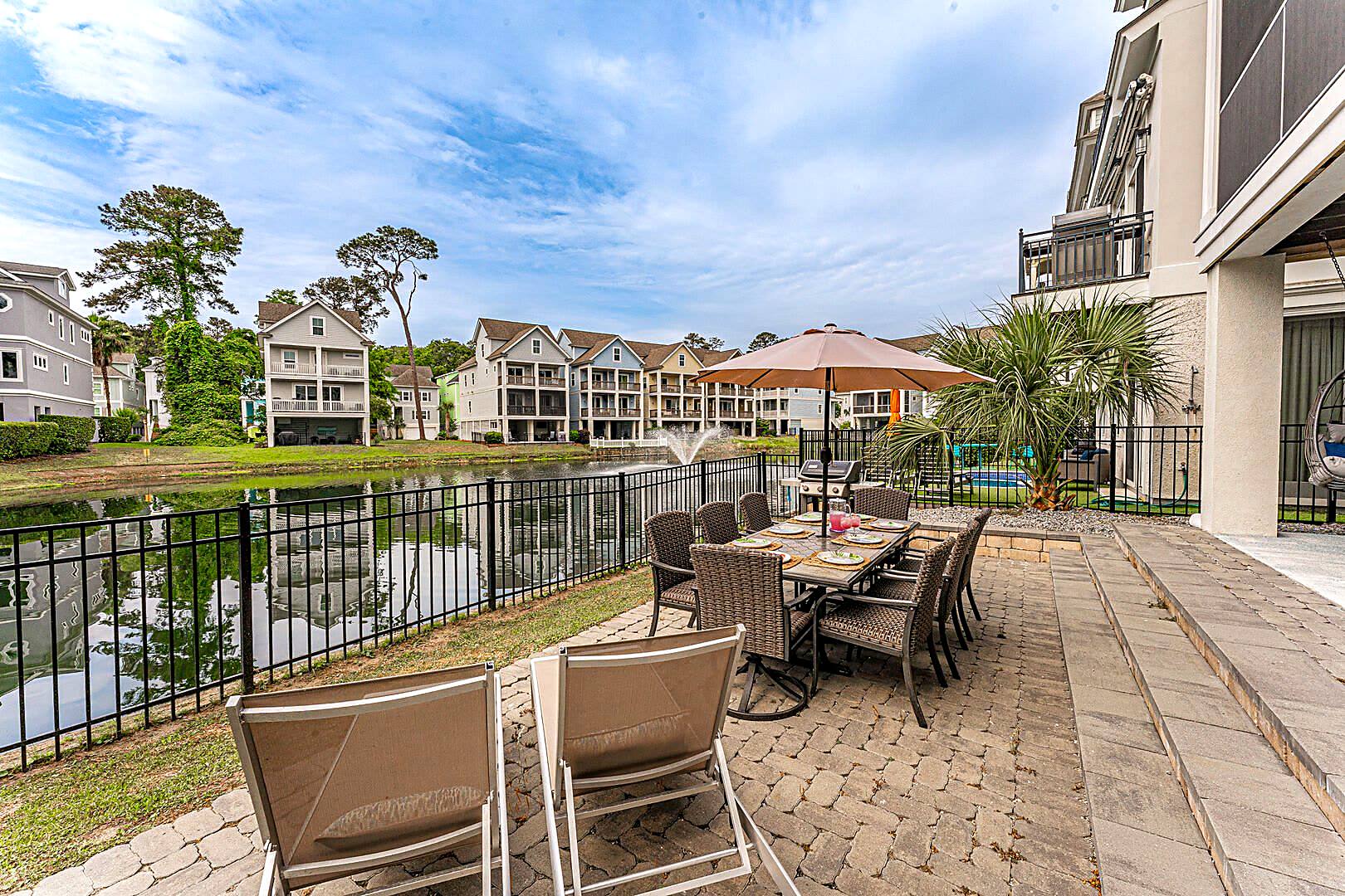 Paver patio and dining table beside the lagoon in the Sandcastles by the Sea community, Hilton Head Island