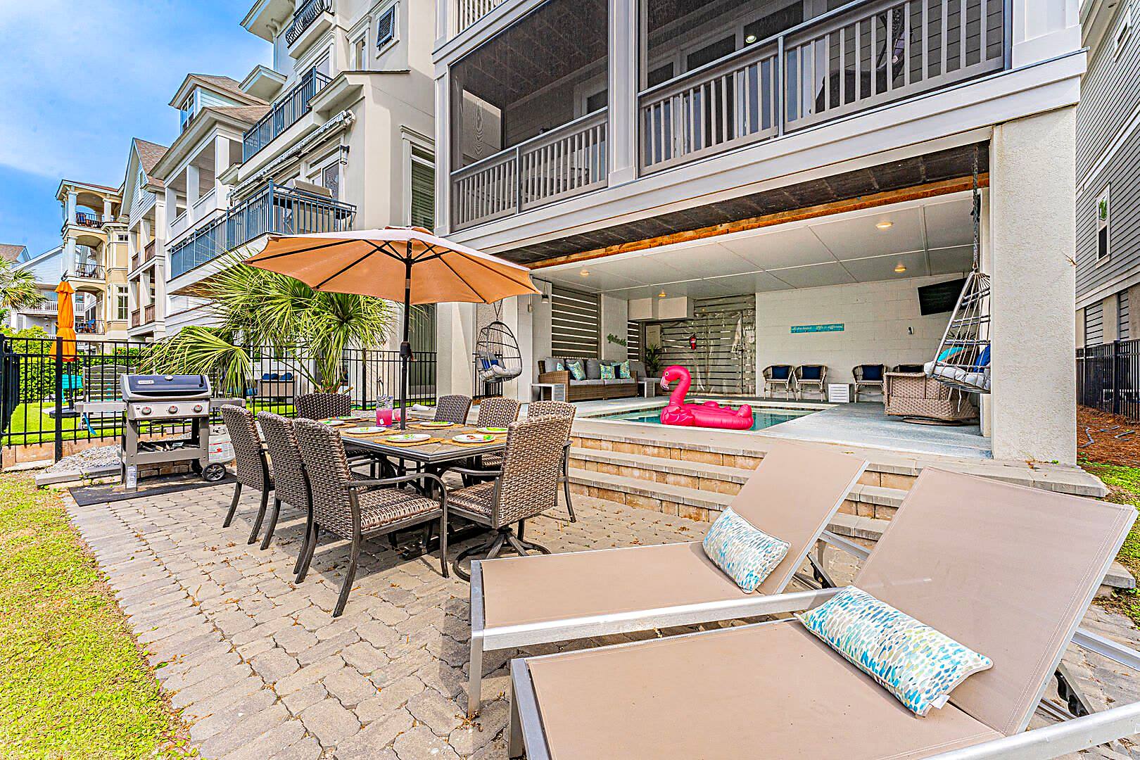 Heated private pool, paver patio, gas grill and lagoon at a six-bedroom Hilton Head Island rental near Folly Field Beach