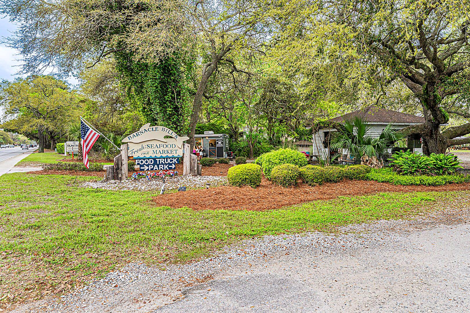 Barnacle Bill's Fresh Seafood Market and Food Truck Park sign under live oaks on Hilton Head Island