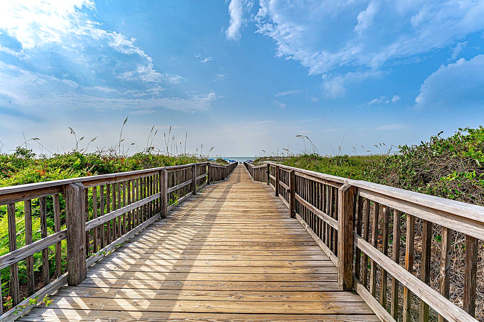 Long wooden boardwalk crossing sea oat dunes toward the Atlantic on the north end of Hilton Head Island